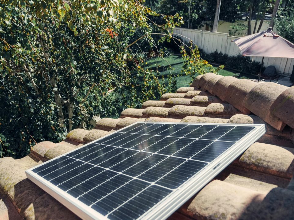 A black solar panel on a roof